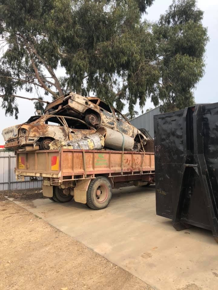 A Truck Is Carrying A Pile Of Old Cars — RiverCity Recyclers In Forster, NSW