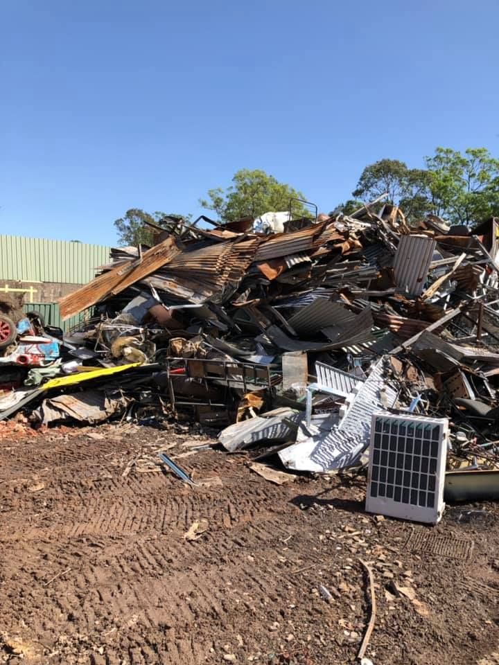 A Pile Of Scrap Metal Is Sitting On Top Of A Dirt Field — RiverCity Recyclers In Taree, NSW