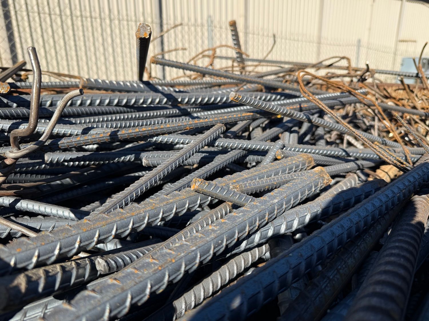 Stacked steel rebar rods in a construction yard