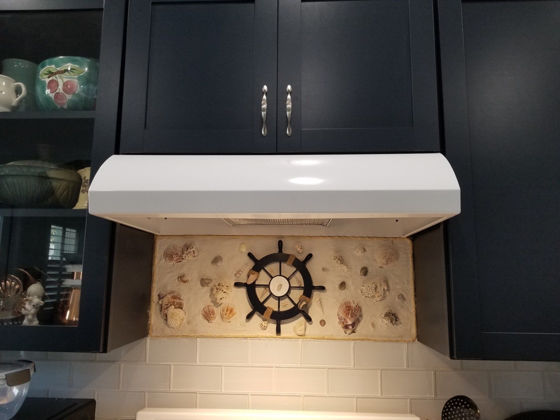 installed exhaust and light in between kitchen cabinets