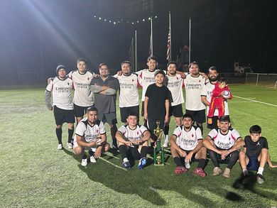 Baseball player sliding into home plate, catcher in front. Blue and gold uniforms, action shot.