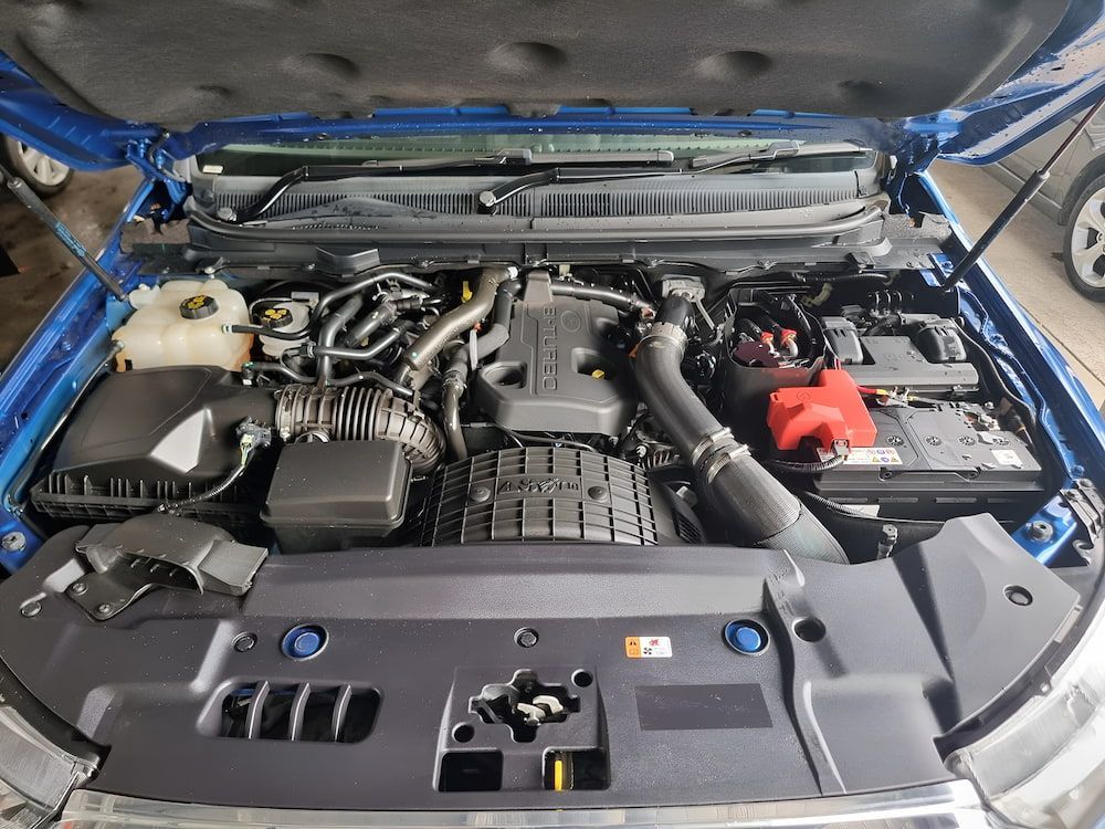 The Engine Of A Blue Car Is Shown With The Hood Open — Apex Automotive Detailing In Lismore, NSW