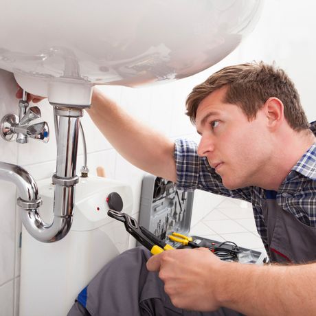 Man Repairing Sink — Bloomington, MN — Richfield Plumbing Company