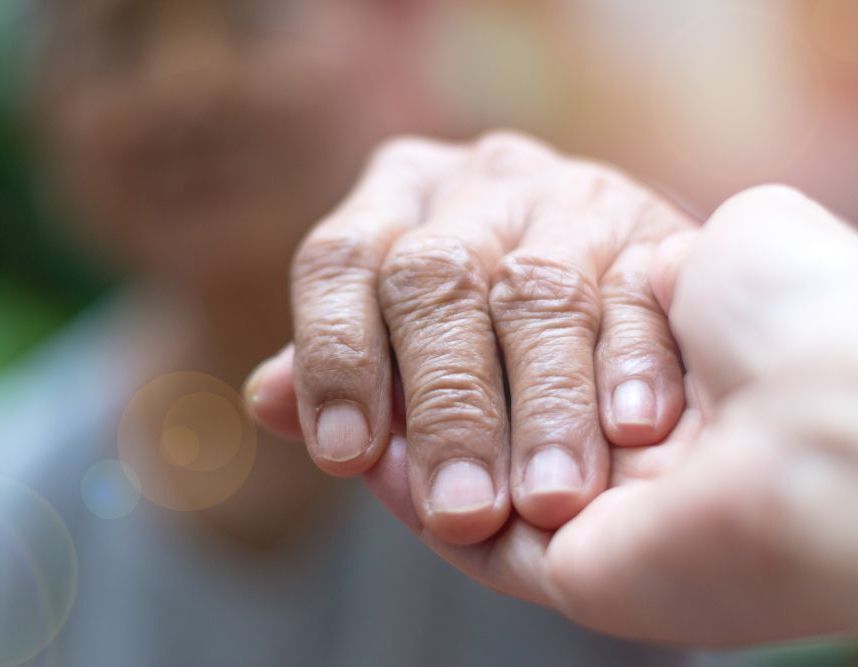 A Close Up of a Person Holding an Older Person 's Hand — Home Nursing Services In Port Macquarie, NSW