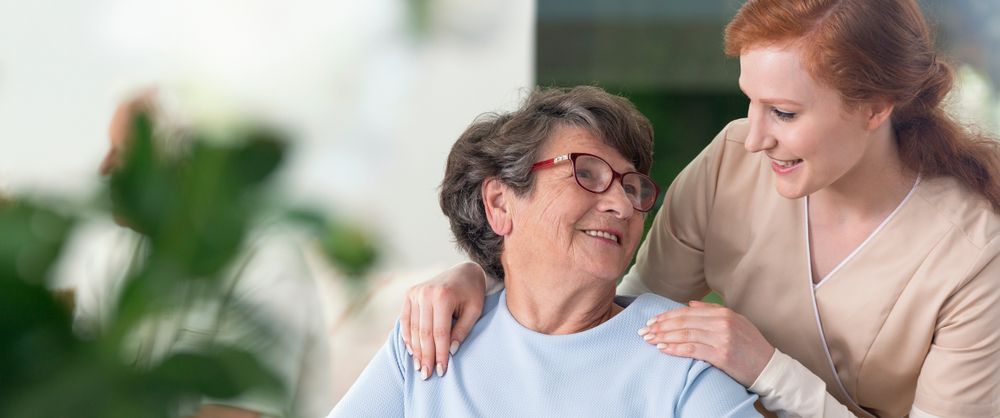 A Woman Is Putting Her Arm Around An Older Woman's Shoulder — Home Nursing Services In Newcastle, NSW