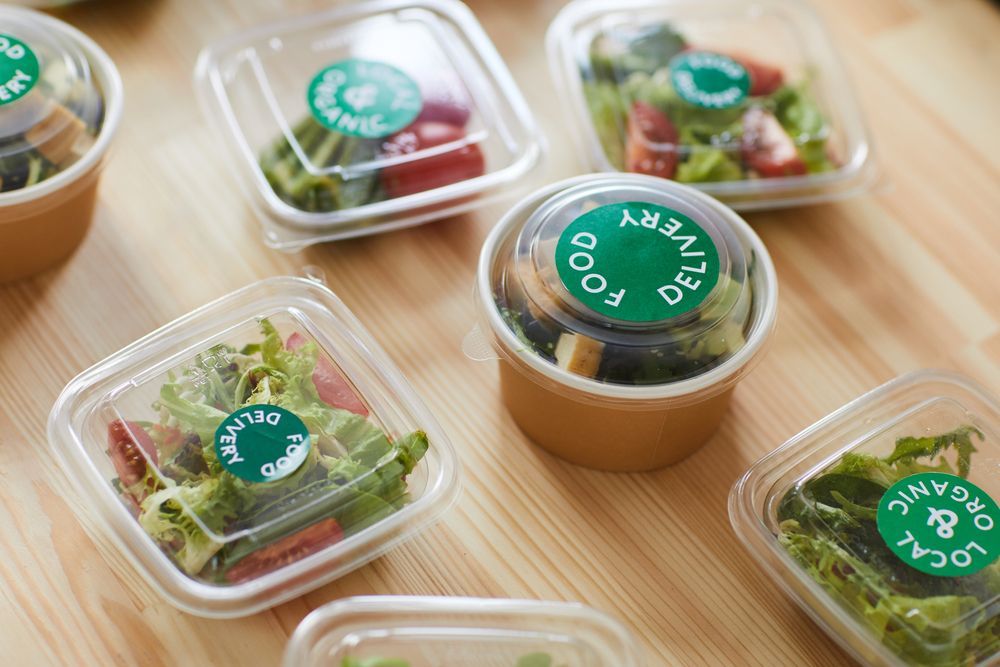 A Wooden Table Topped With Plastic Containers Filled With Food — Home Nursing Services In Charlestown, NSW