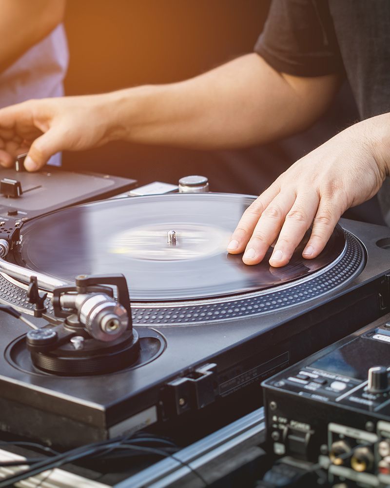 A person is playing a record on a turntable