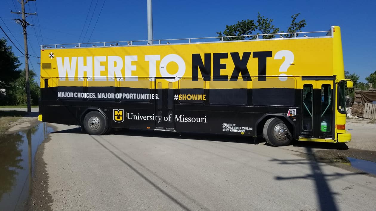 UM Here to Next bus decal