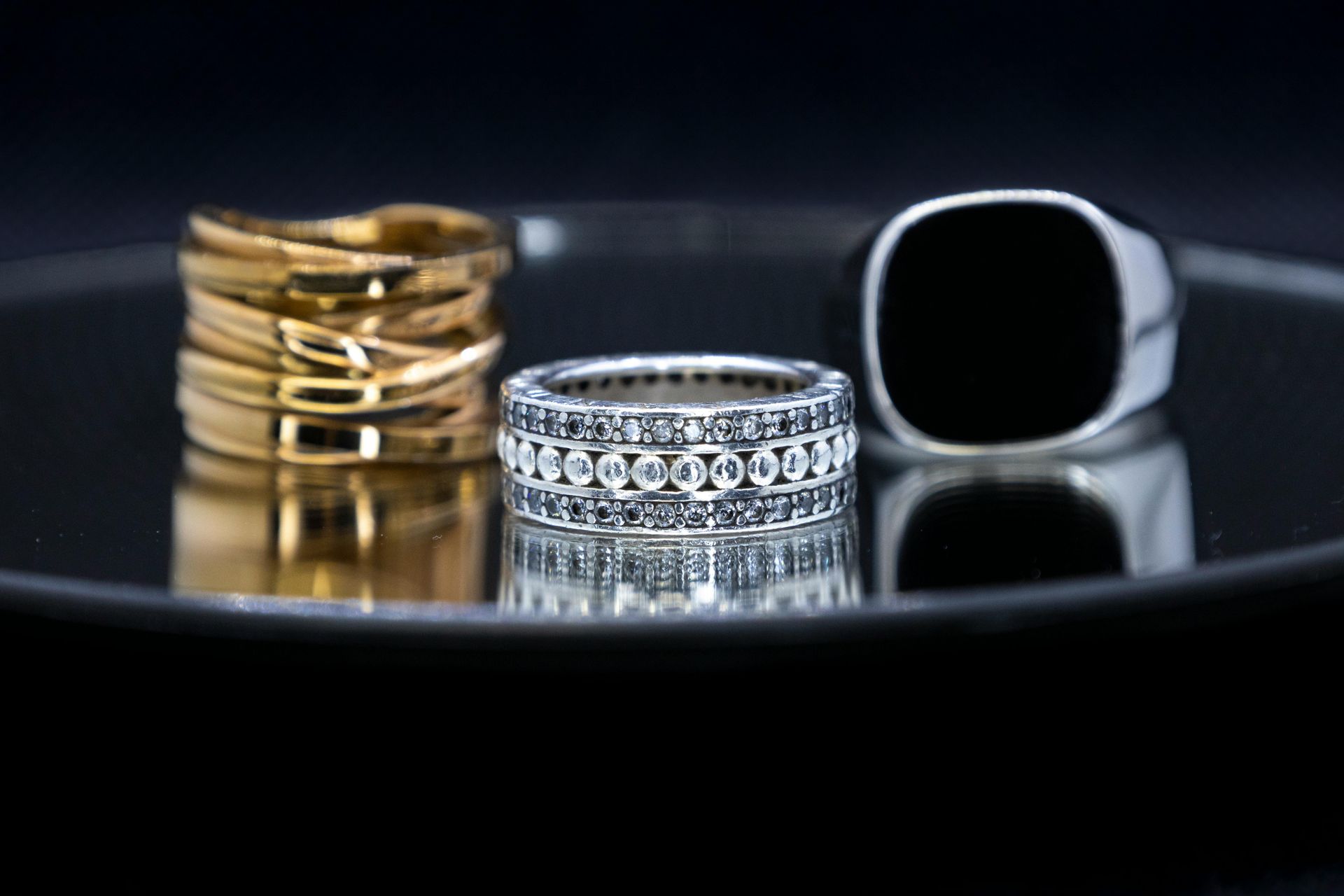 A pair of wedding rings are sitting on top of a gold box.