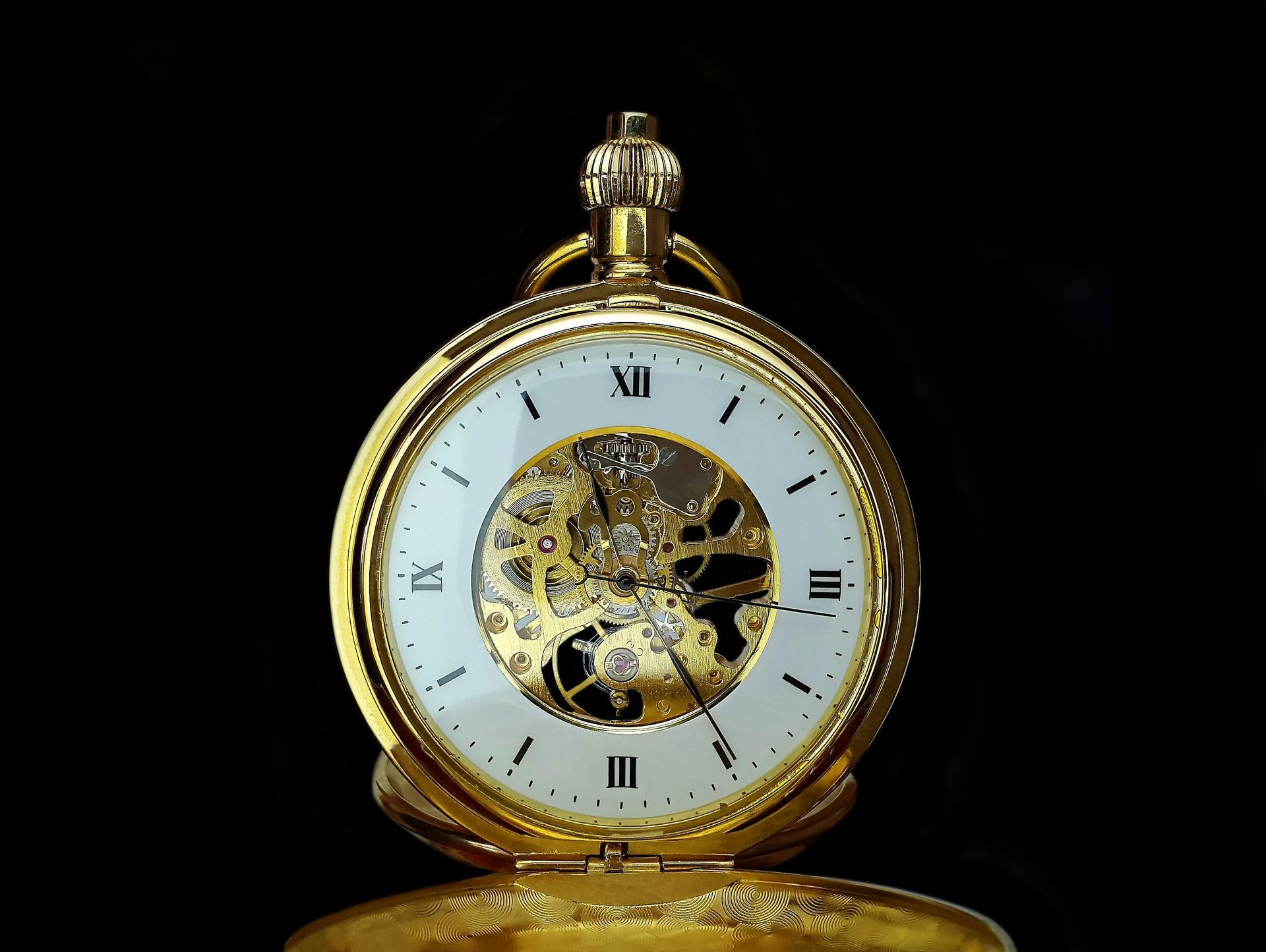 A watch with a brown leather band is sitting on a table.