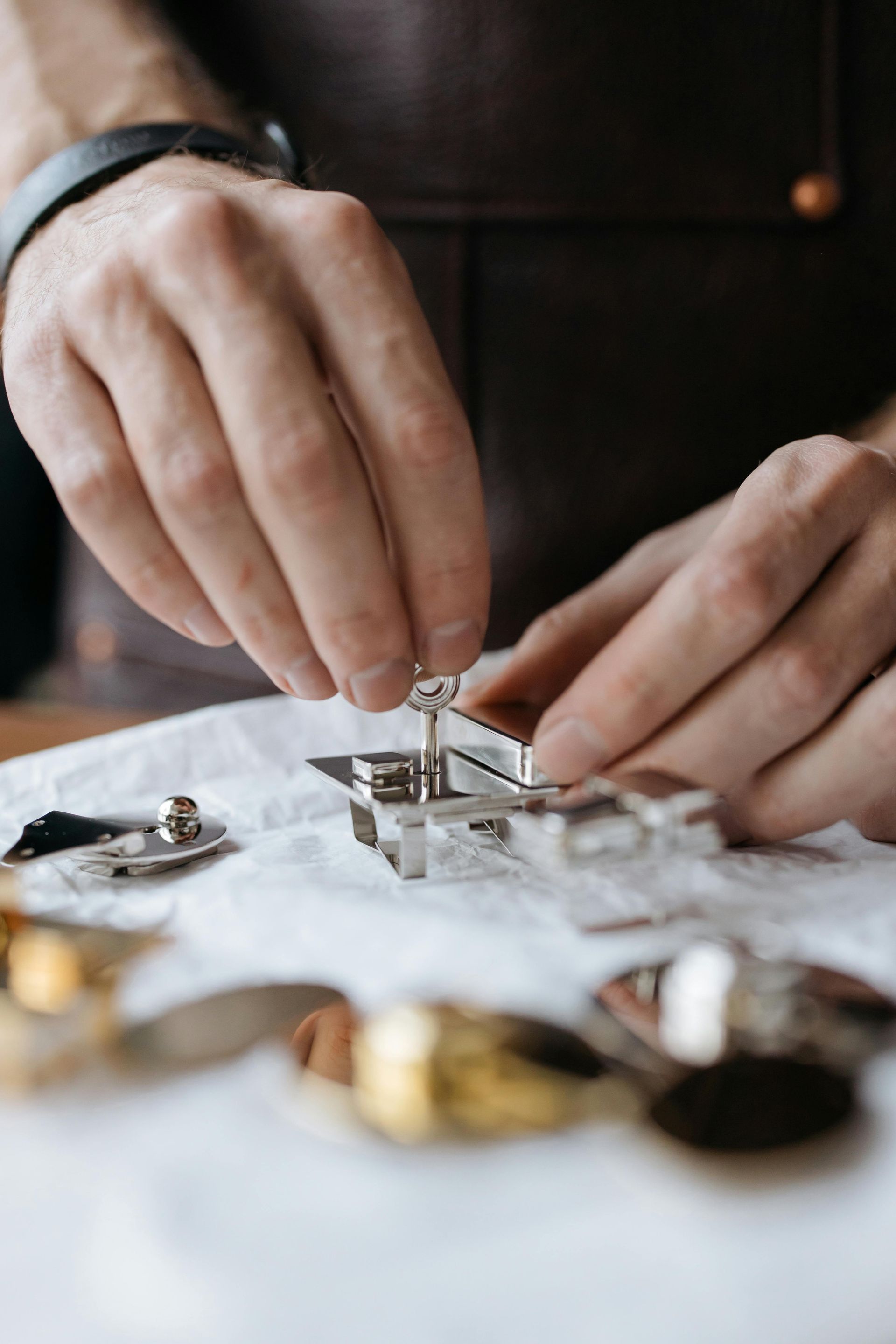 A close up of a person 's hands working on a watch.