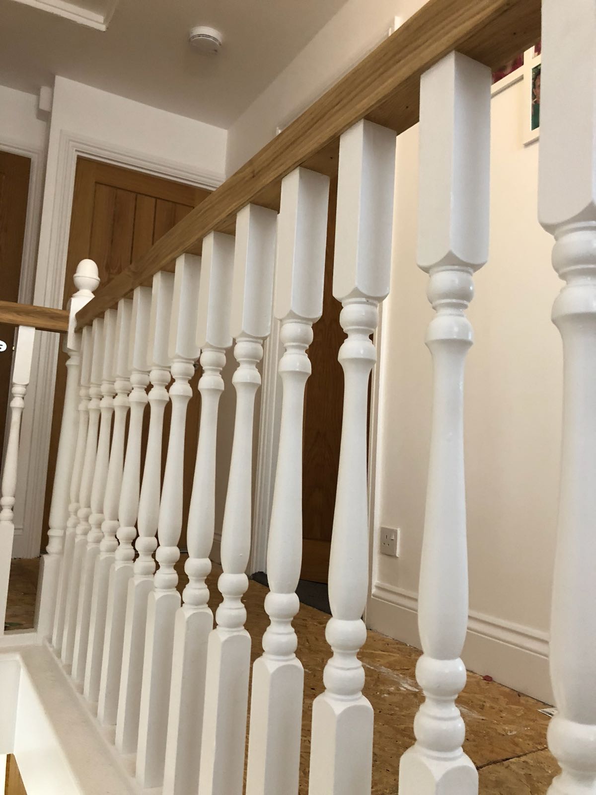 A close up of a white railing on a staircase