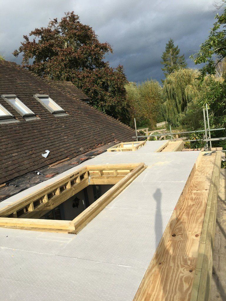 The roof of a house is being built with a wooden frame.