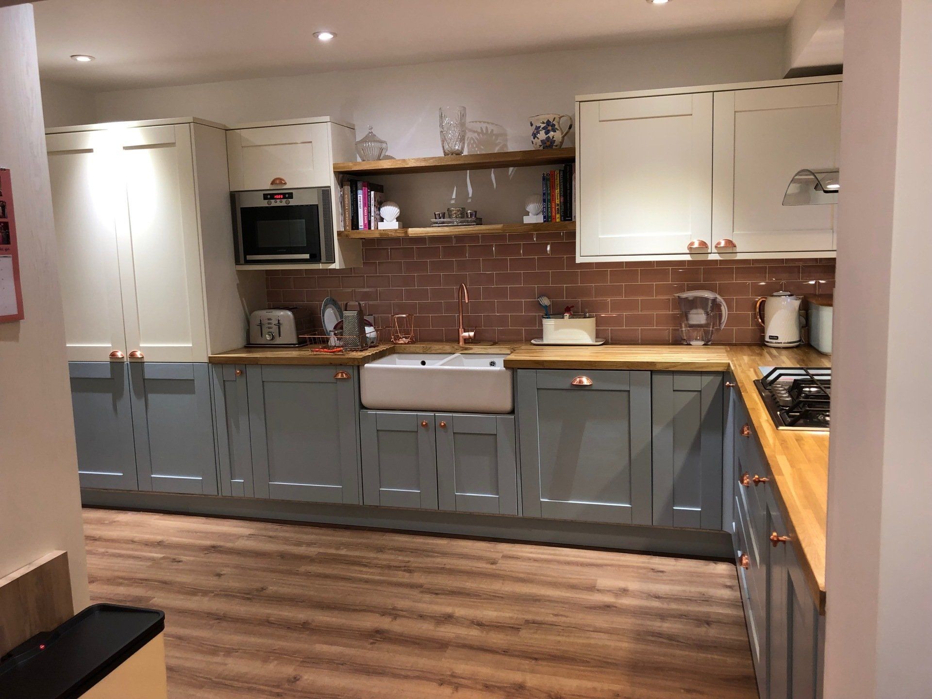 A kitchen with a sink , stove , and microwave.