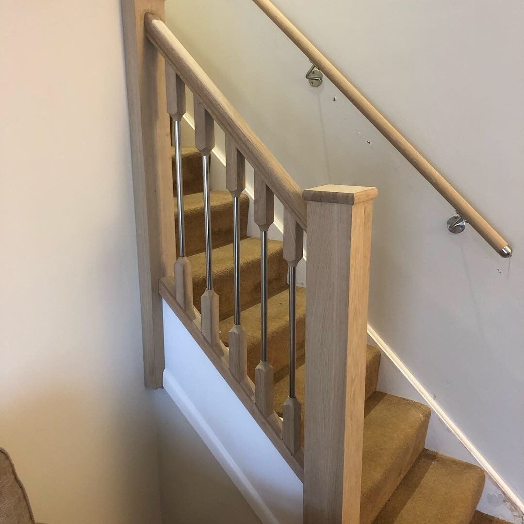 A staircase with a wooden railing and a glass railing