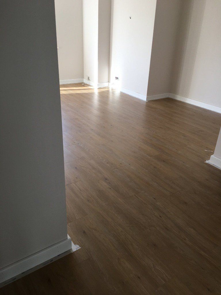 A room with a wooden floor and white walls.