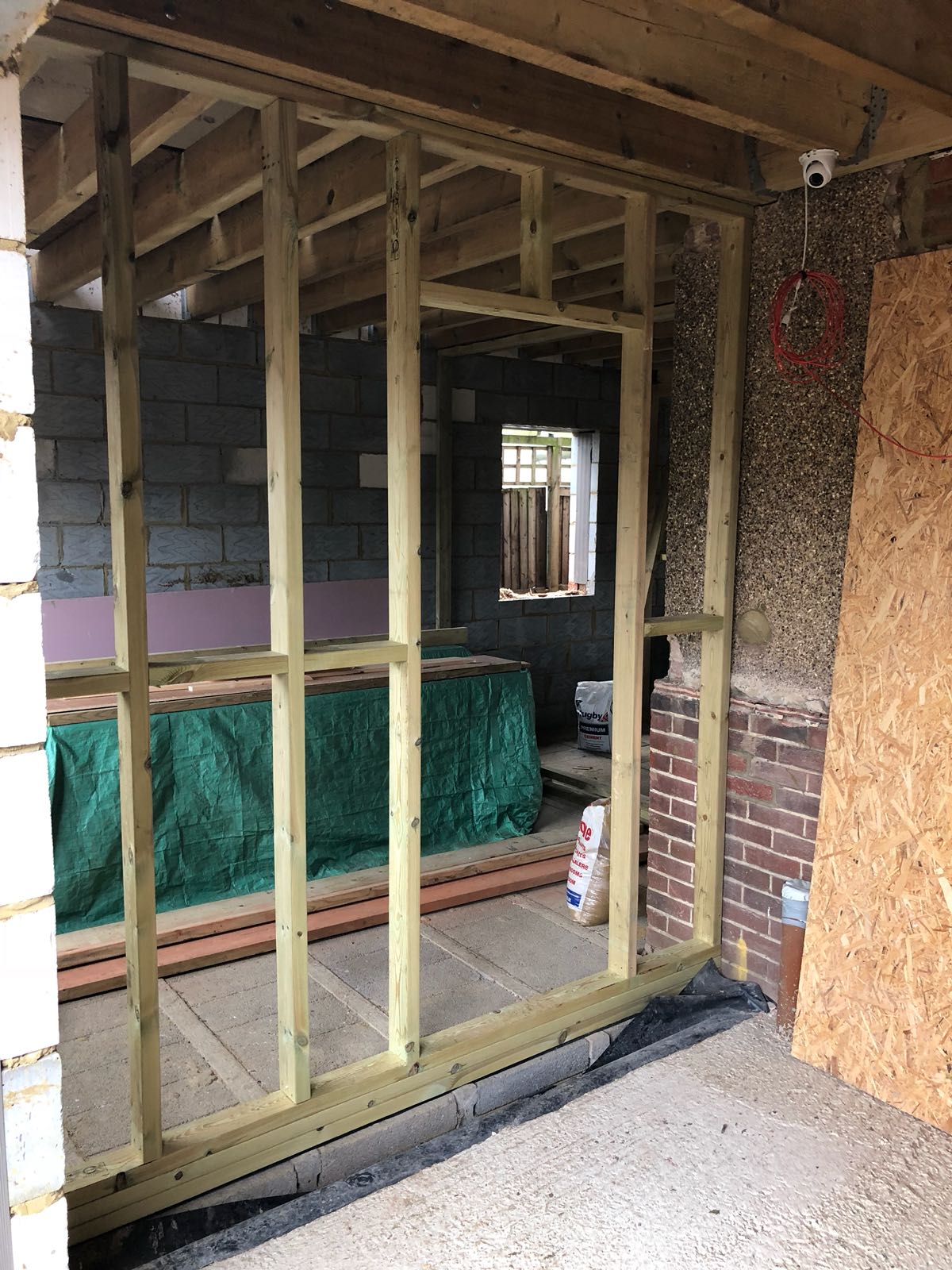 A room with a wooden frame and a brick wall.