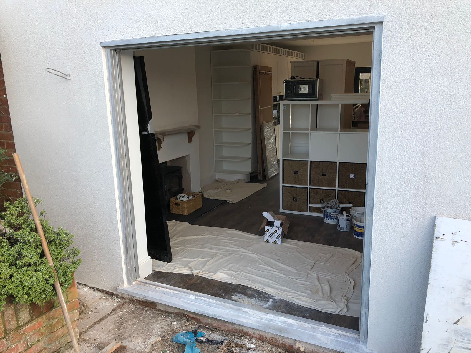 A sliding glass door is open to a living room.