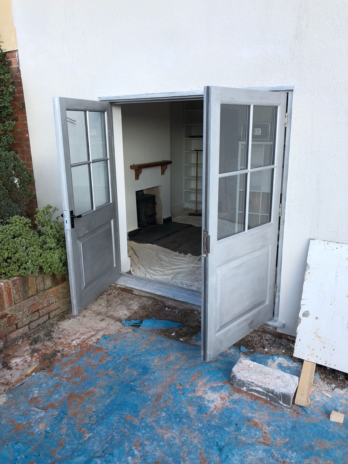 A white door is open to a room with a fireplace.