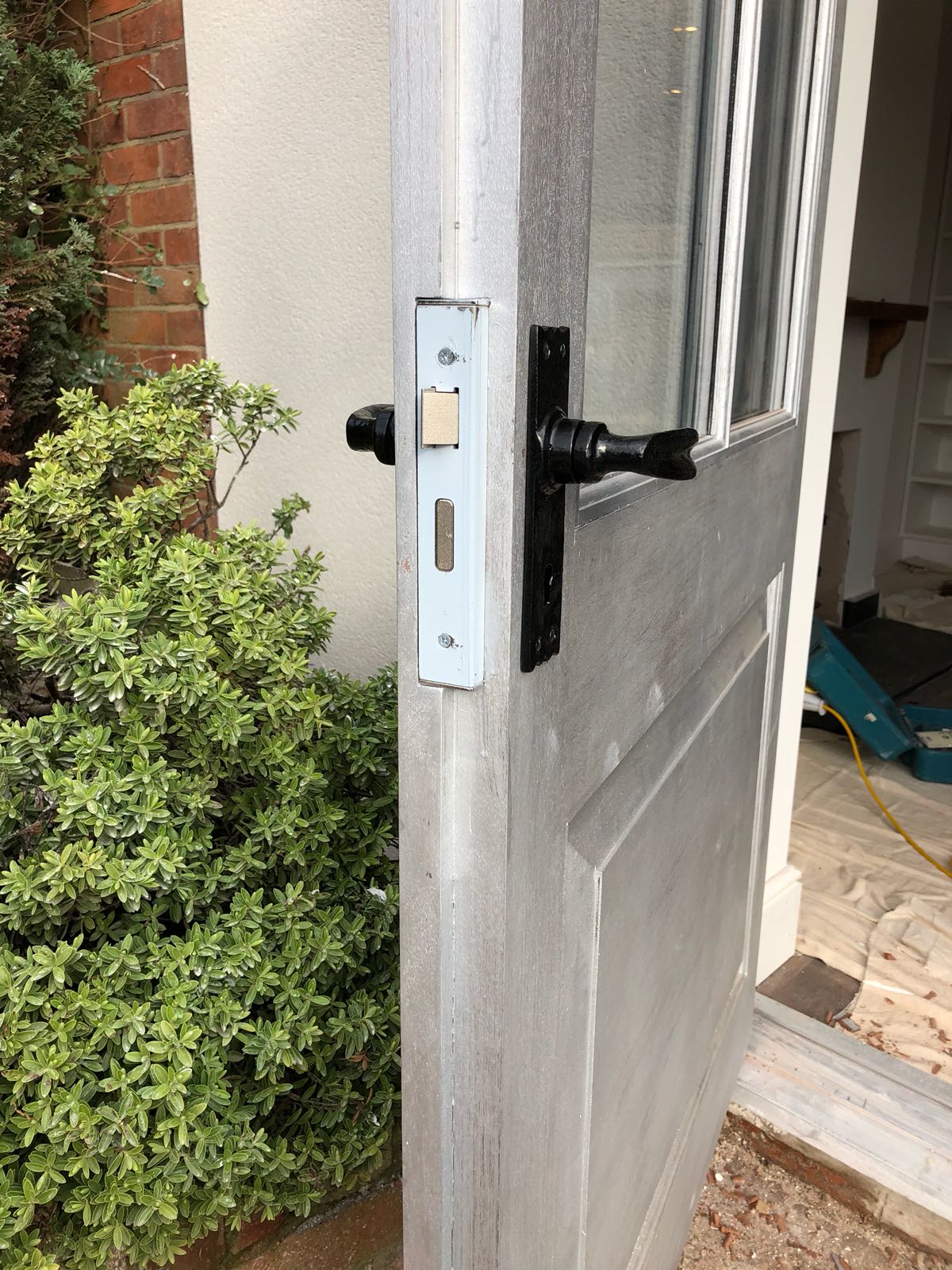A close up of a door with a black handle.