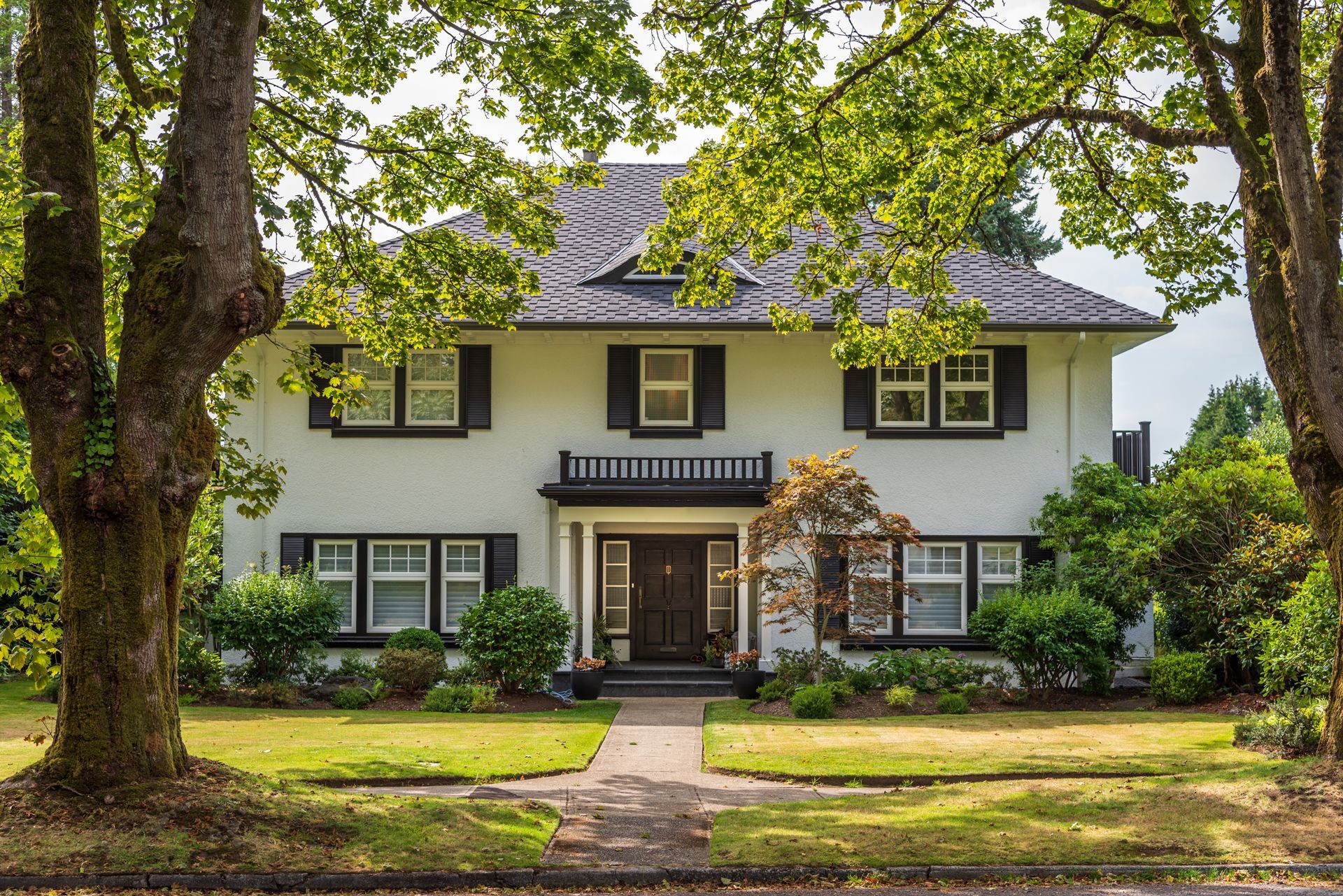 Two-story white house with black shutters
