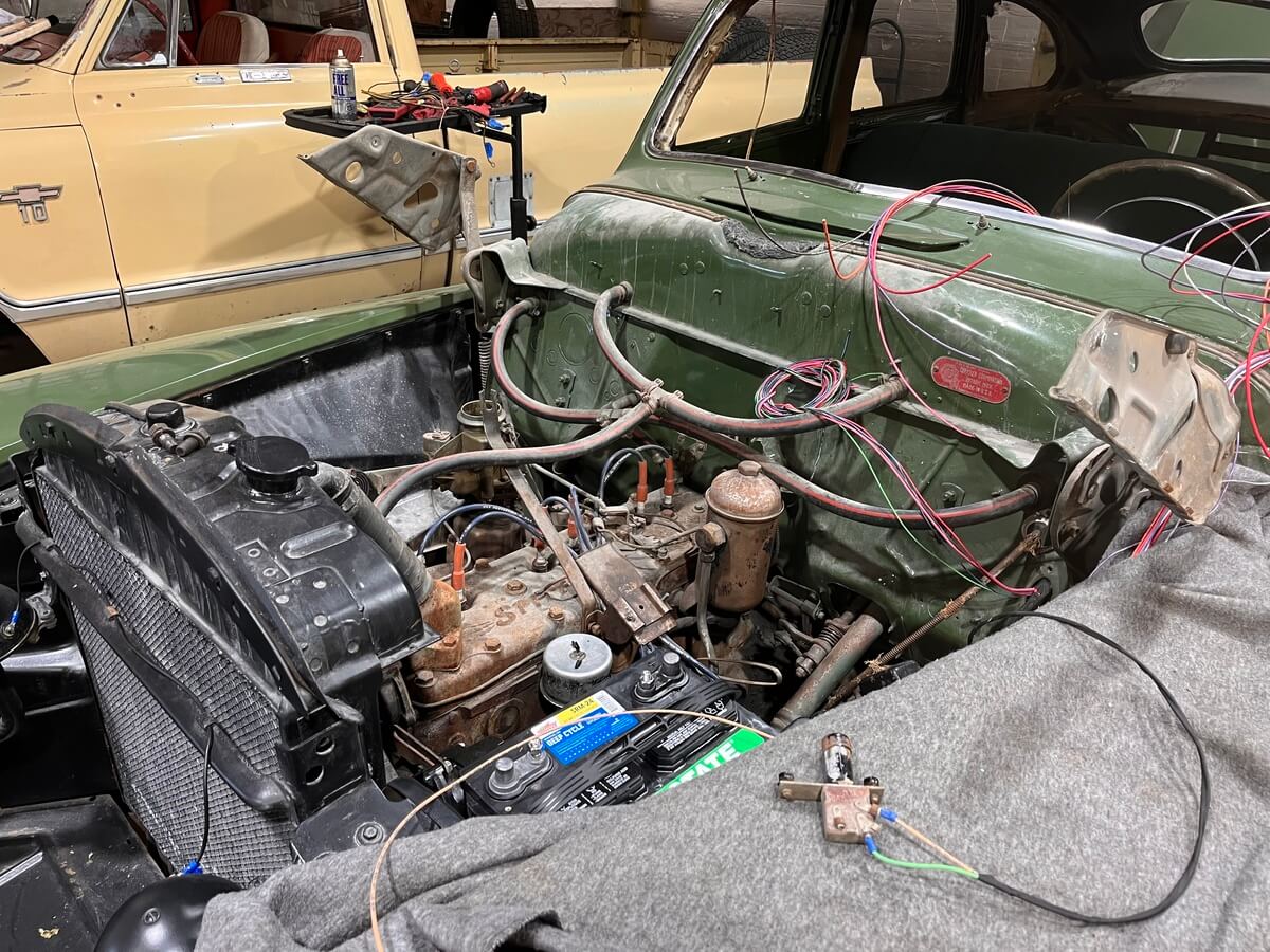 A car engine is being worked on in a garage.