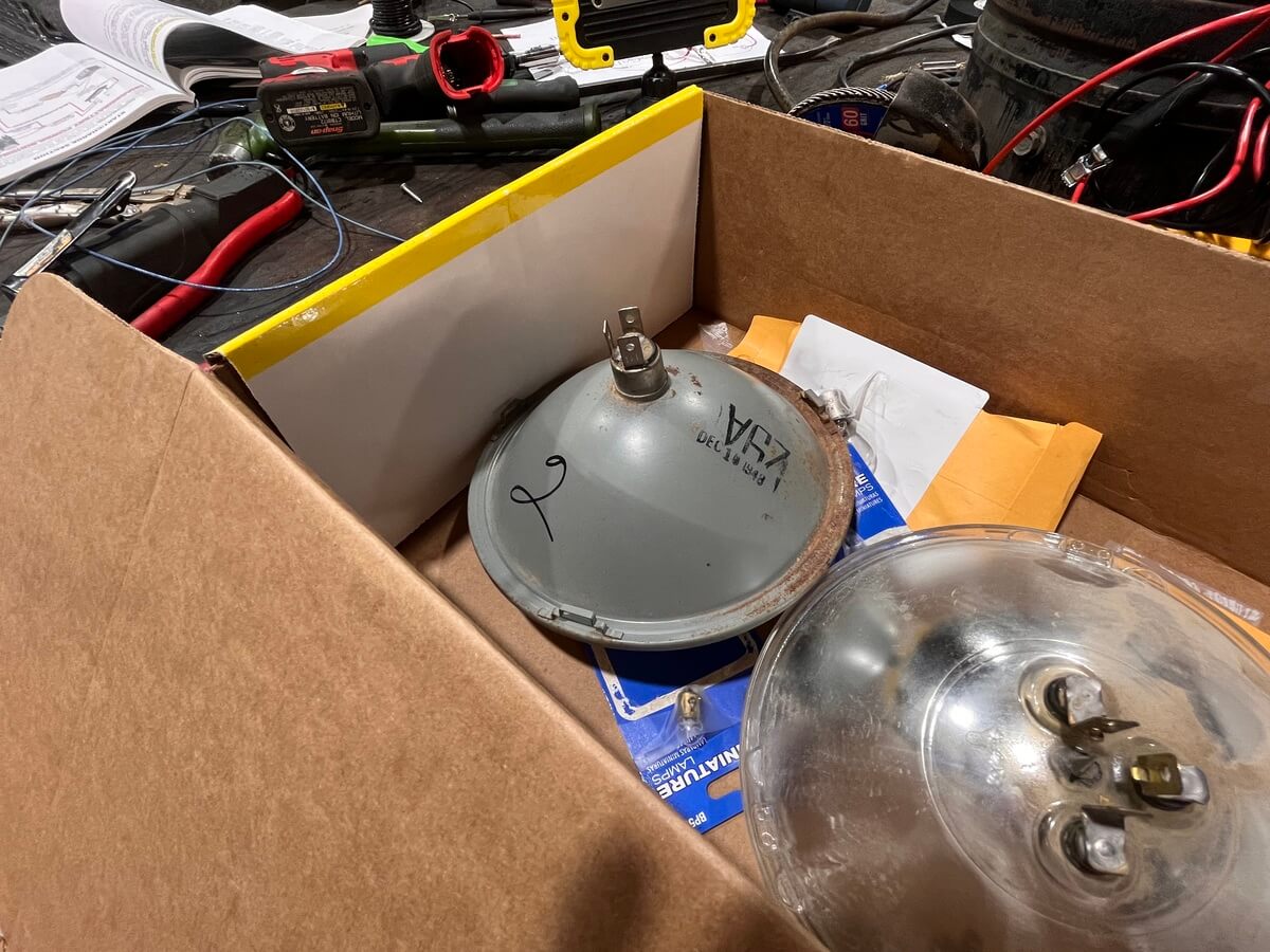 A cardboard box filled with a light bulb and other items