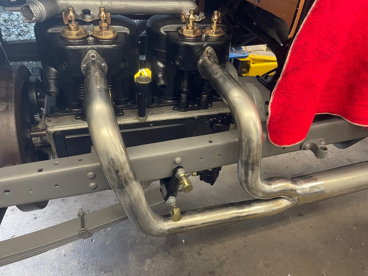 A close up of a car engine with a red towel on it.