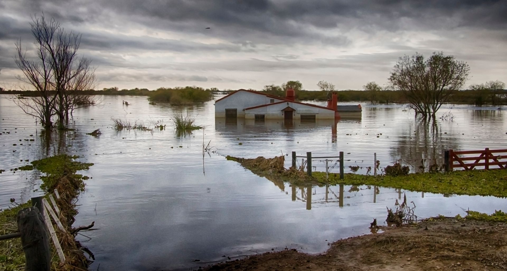 A flooded area with a house in the middle of it