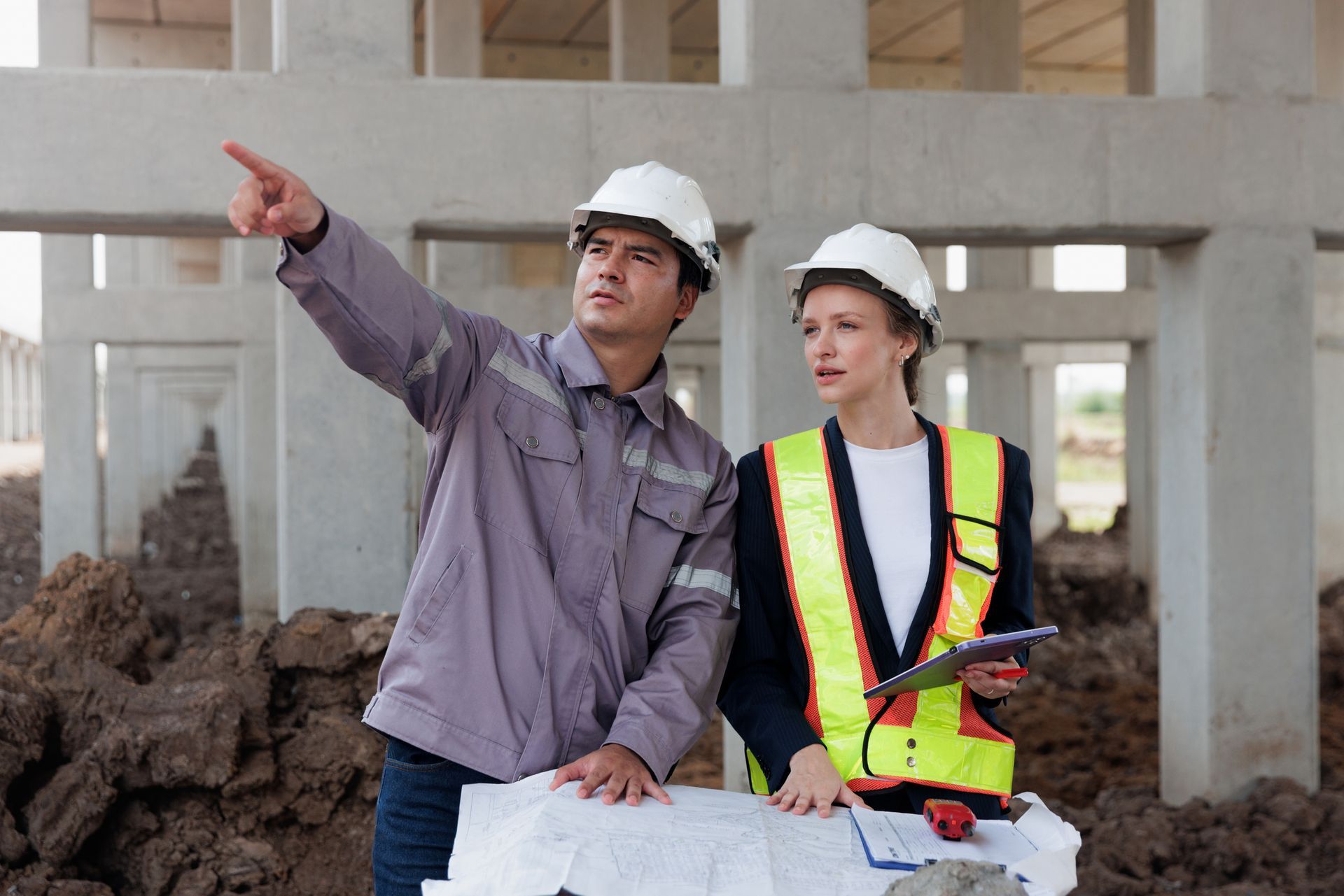 Two civil engineers working together under the expressway.