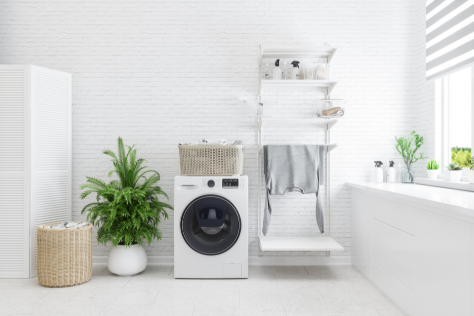 A bathroom with a washing machine , baskets , plants and a bathtub.