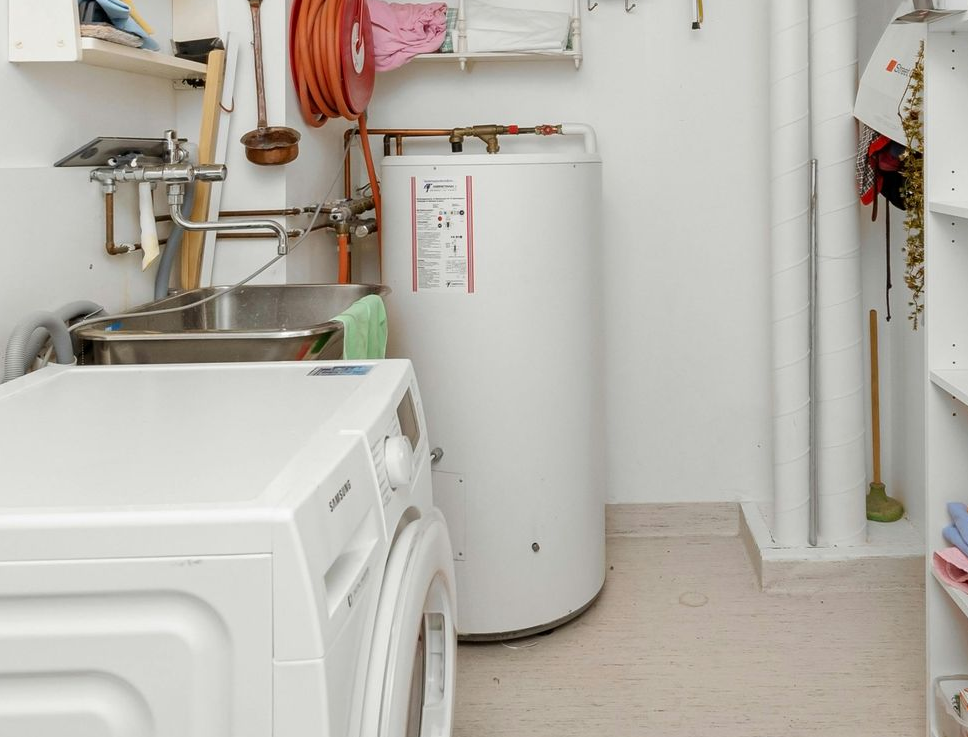 A laundry room with a washer and dryer and a sink.