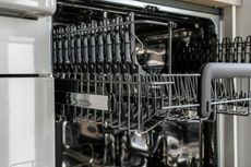 A close up of a dishwasher with the door open.
