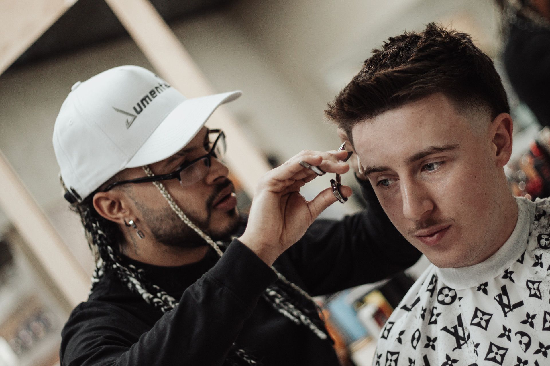 A Barber is Blow Drying a Man's Hair in a Barber Shop — Barber Bros & Co - Southport in Broadbeach, QLD