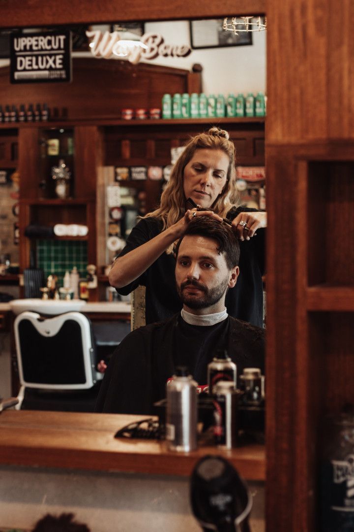 Women Cutting Man's Hair In Barber Shop — Barber Bros & Co - Southport in Isle of Capri, QLD