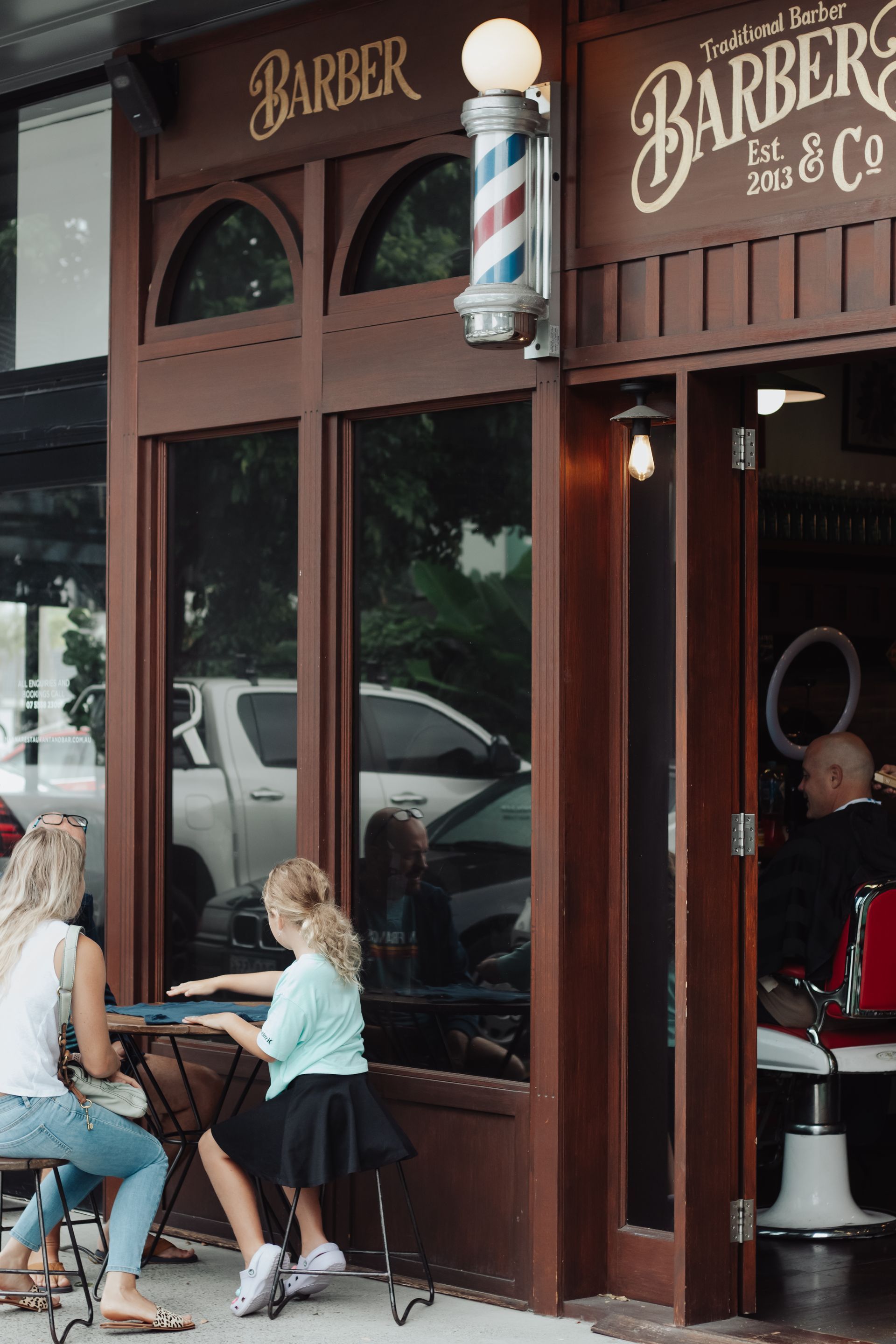 A Barber Cutting Client's Hair With Scissors — Barber Bros & Co - Southport in Southport, QLD
