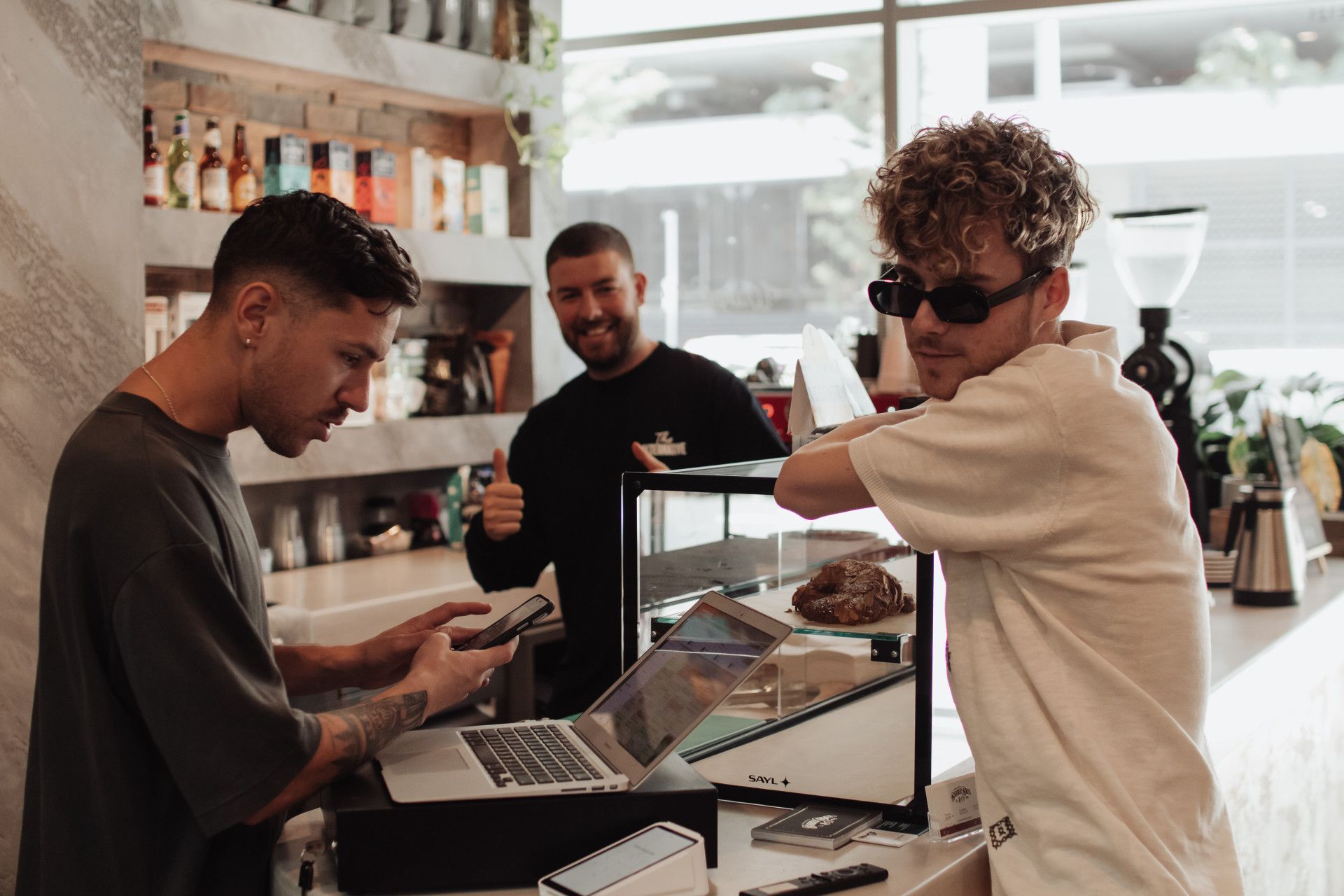 Man Booking in Appointment At Counter Of Barber Shop — Barber Bros & Co - Southport in Broadbeach, QLD