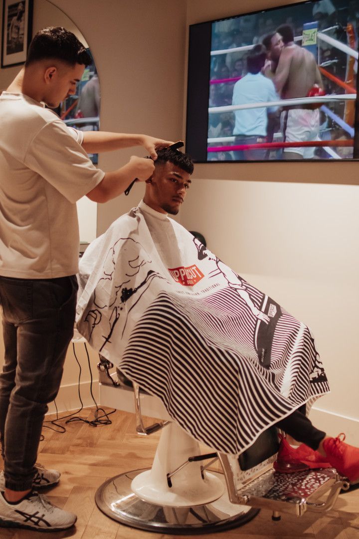 Barber Giving A Man Sitting Down A Fade — Barber Bros & Co - Southport in Southport, QLD