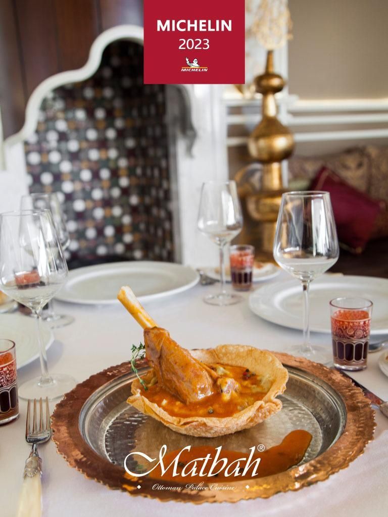 Michelin guide cover with lamb dish at Matbah restaurant, 2023.