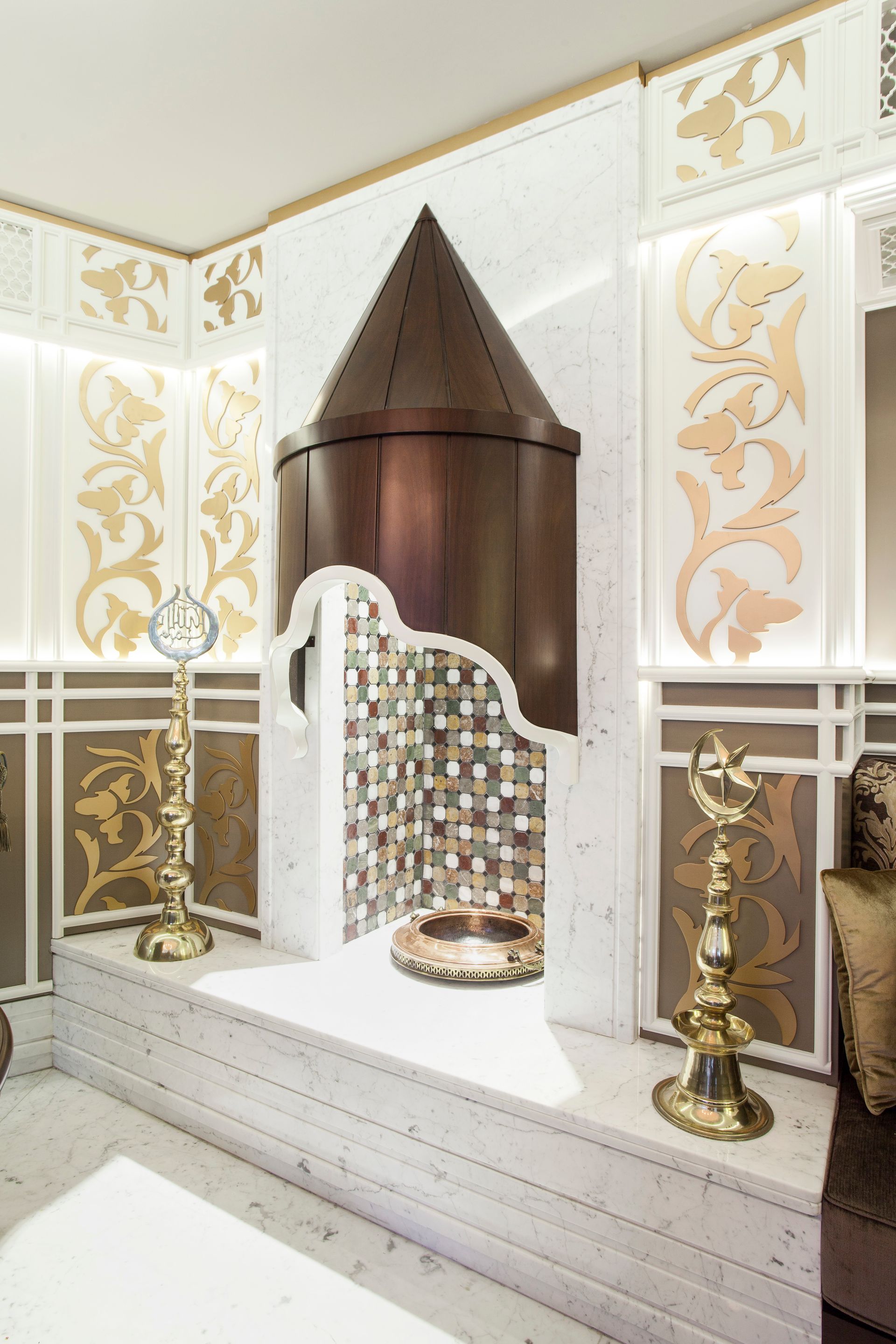 Ornate spa area with copper accent, gold detailing, and mosaic tile.