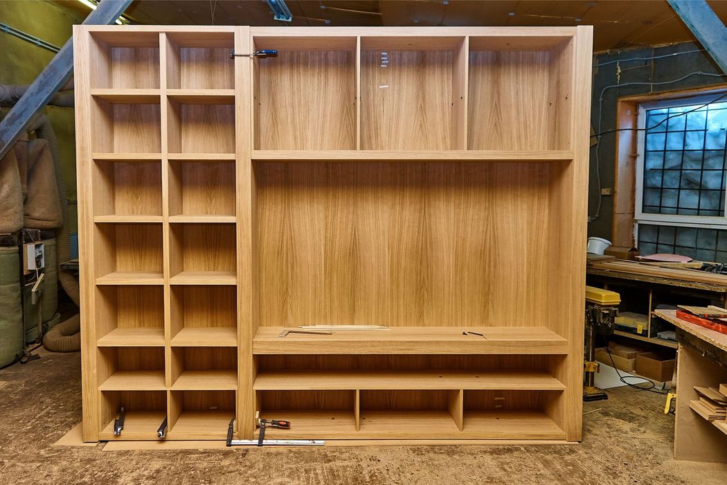 Wooden built-in shelving unit, natural oak finish.