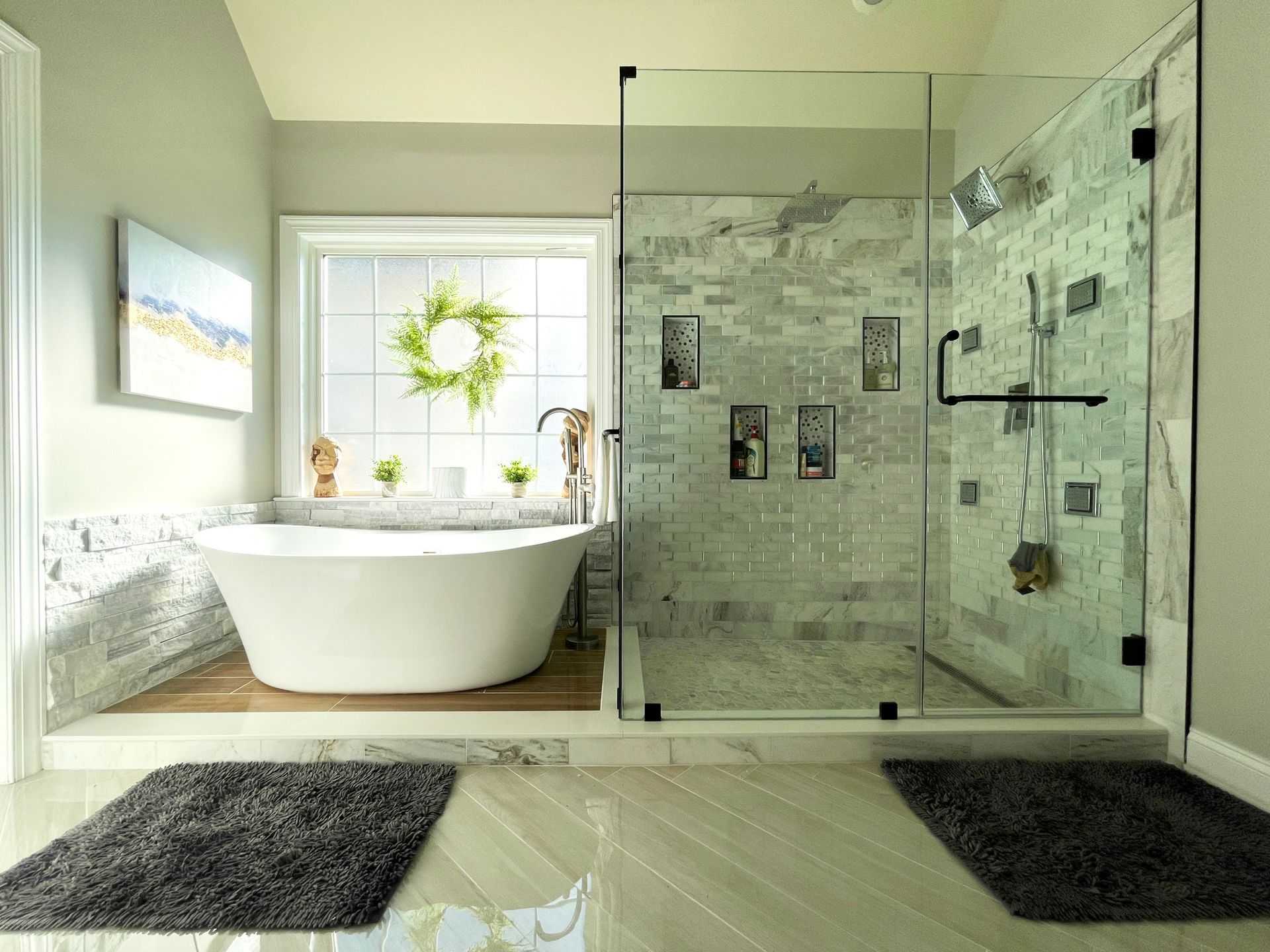 A bathroom with a bathtub and a walk in shower.