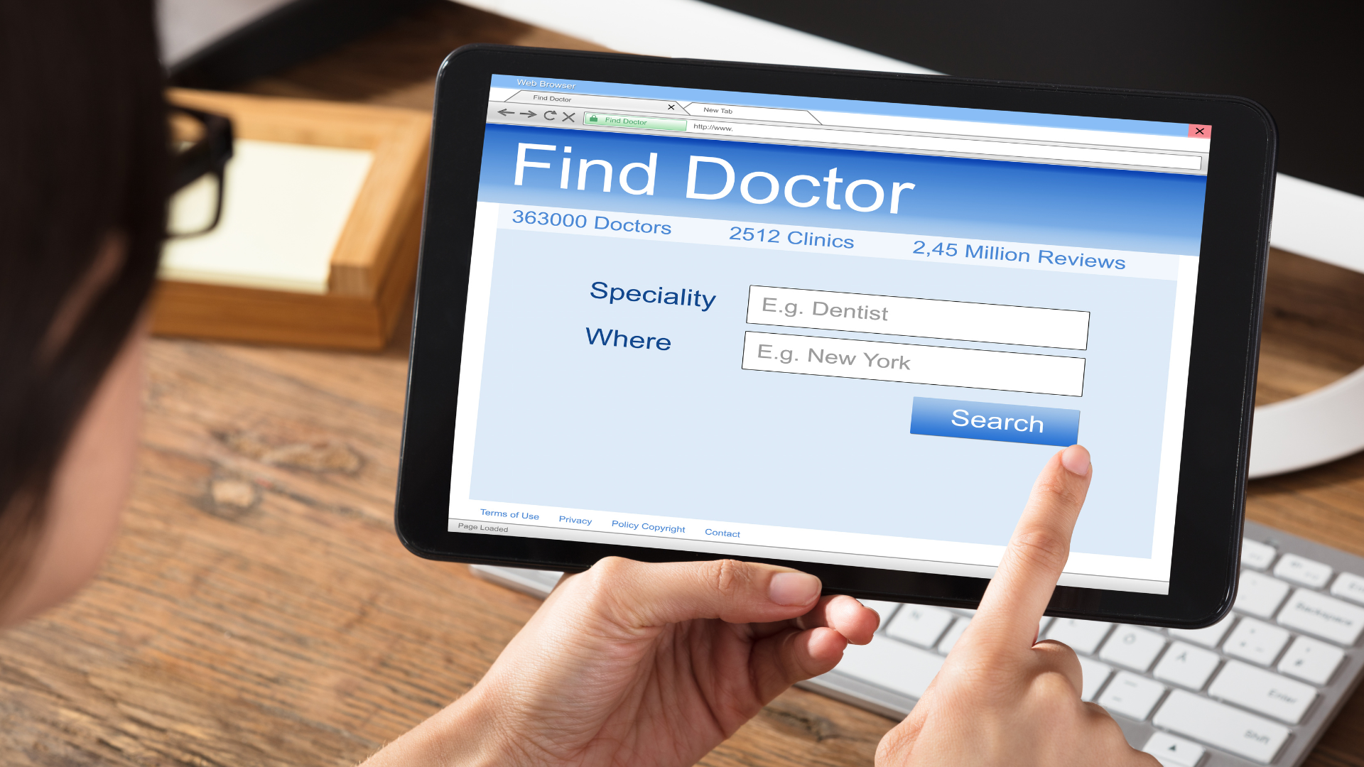 a person is searching for a doctor on a tablet