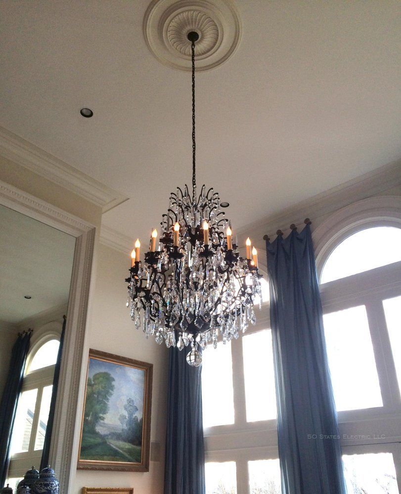 A large chandelier is hanging from the ceiling in a room