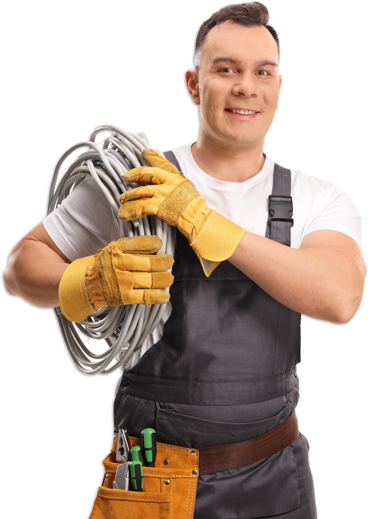 A man in overalls is holding a coil of wires.