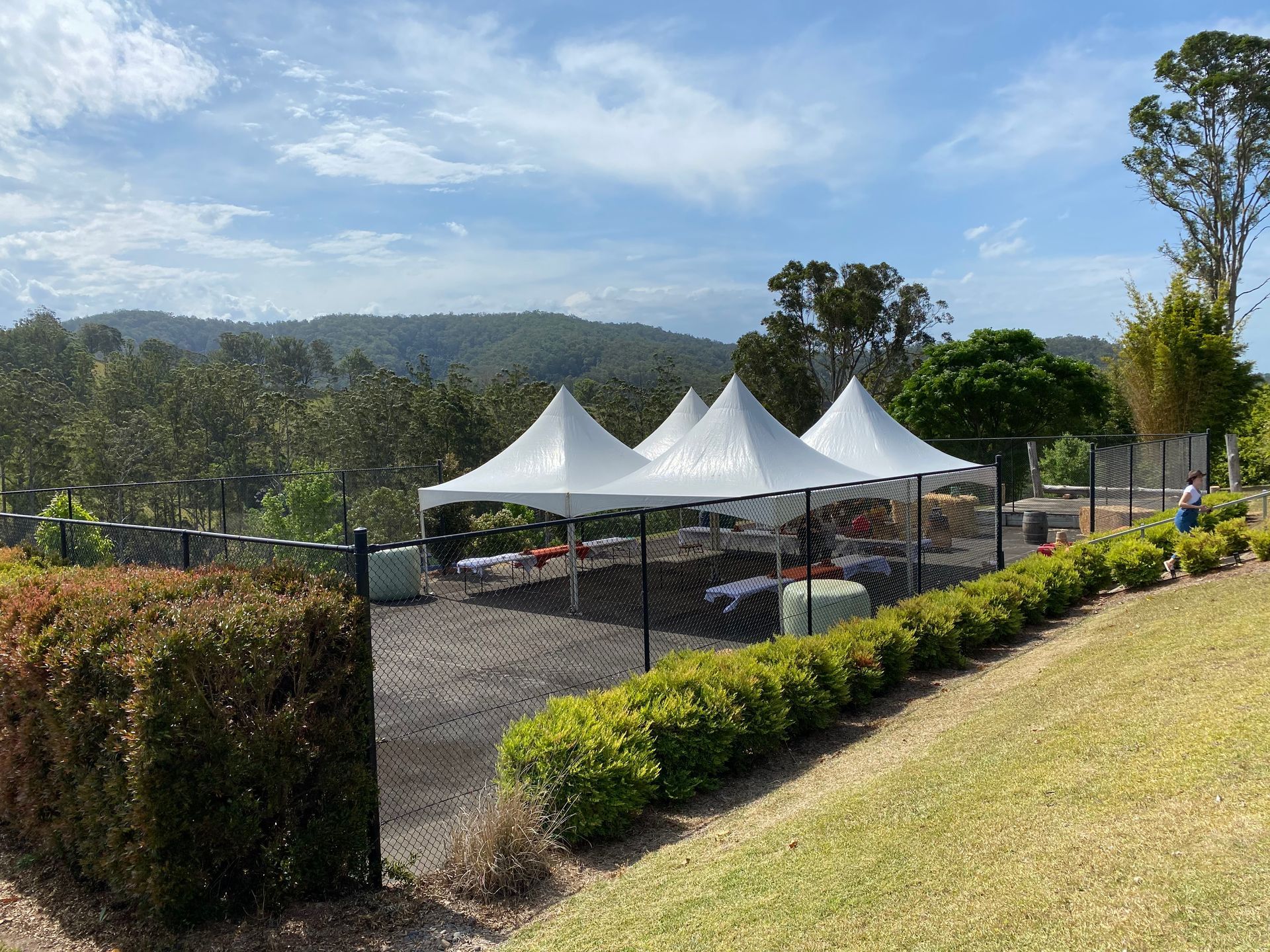 A Group Of Tents Are Sitting On Top Of A Grassy Hill — Red Shed Hire In Wauchope, NSW