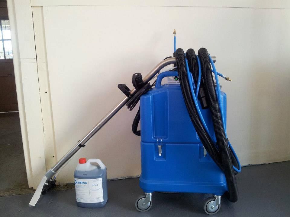 A Blue Vacuum Cleaner Is Sitting Next To A Bottle Of Cleaner — Red Shed Hire In Wauchope, NSW