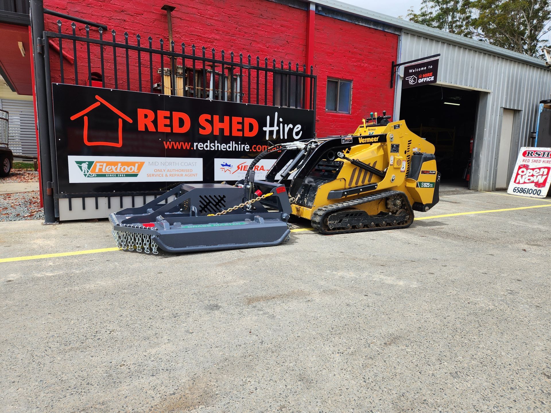 Two Tractors Are Parked In Front Of A Red Shed Hire Building — Red Shed Hire In Wauchope, NSW