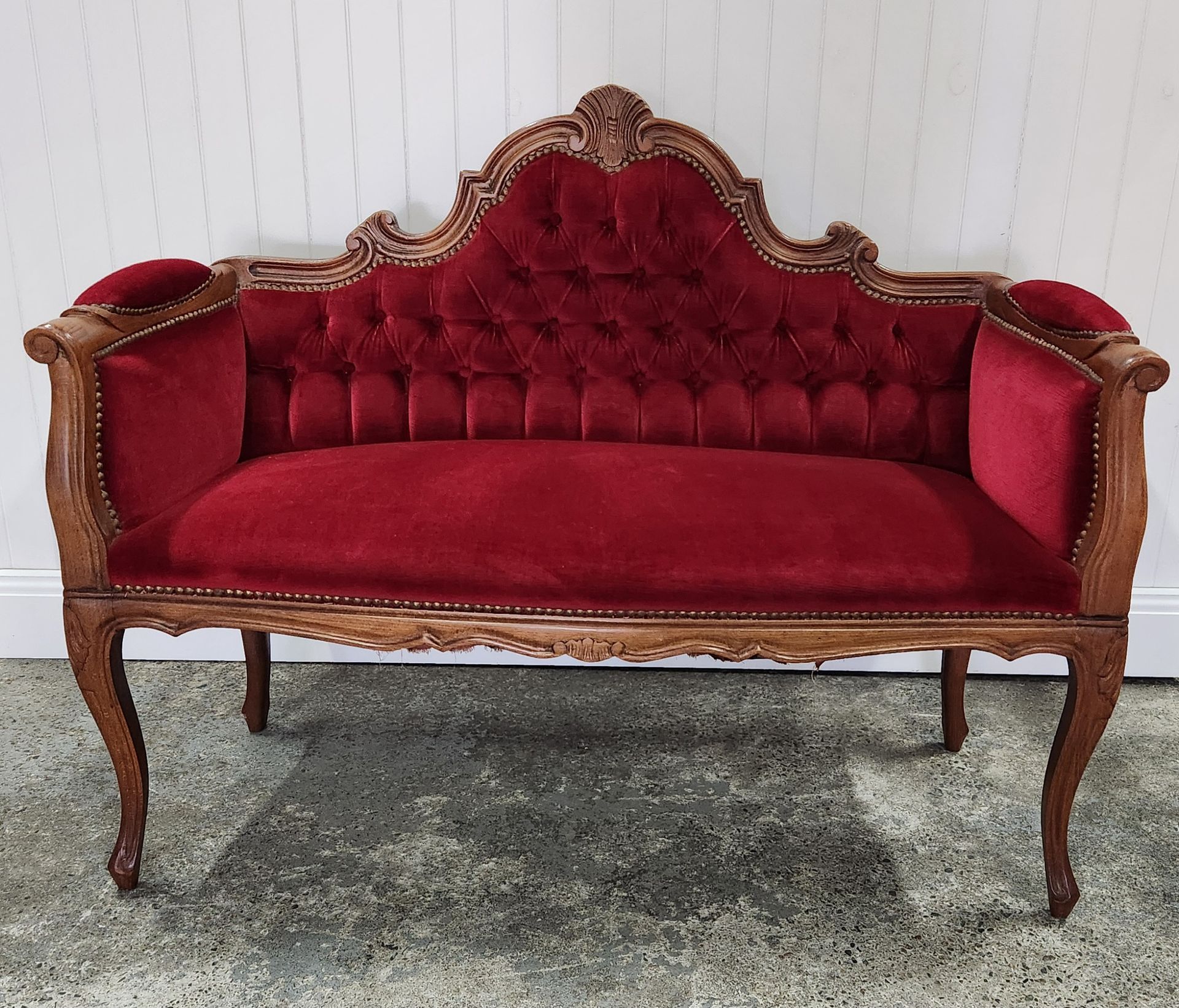 A Red Couch Is Sitting In Front Of A White Wall — Red Shed Hire In Wauchope, NSW