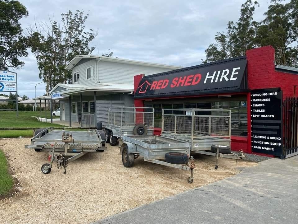 Two Trailers Are Parked In Front Of A Red Shed Hire Building — Red Shed Hire In Wauchope, NSW